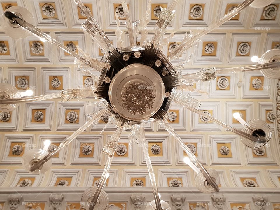 Looking up on a Murano glass chandelier in baroque castle on Isola Bella