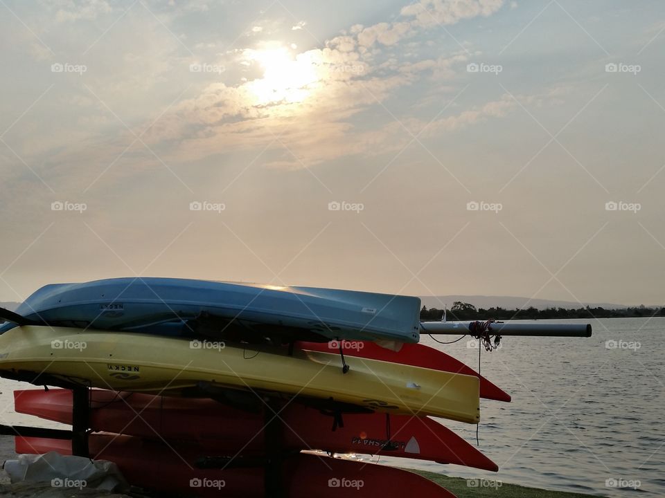 Canoes in a stack. Stack of upturned colorful canoes