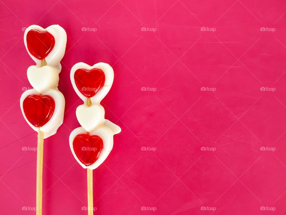 Valentines day red and white candy heart on pink background, love concept