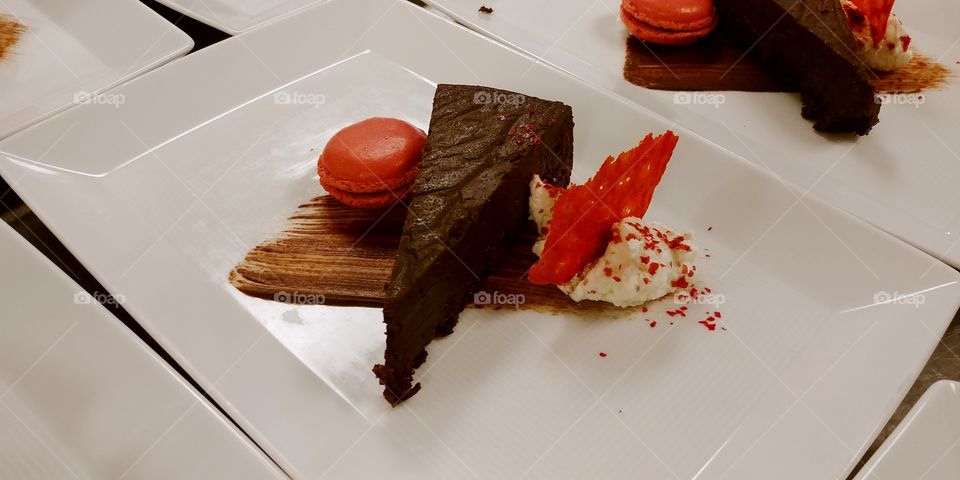 chocolate torte with a raspberry macaroon, fried tuile and whipped cream