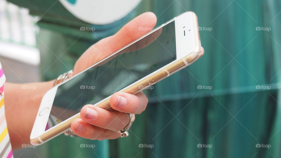 Woman texting. Woman using a brand-new smart phone iphone 6 plus Big screen