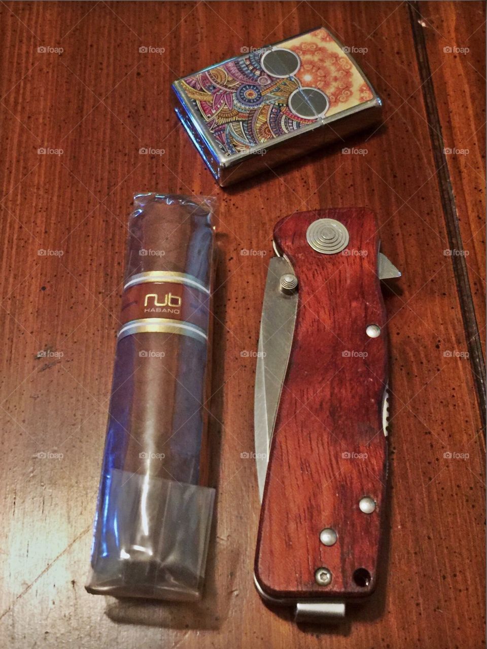 Nub cigar and a SOG brand knife to cut the tip with a Zippo to lite.