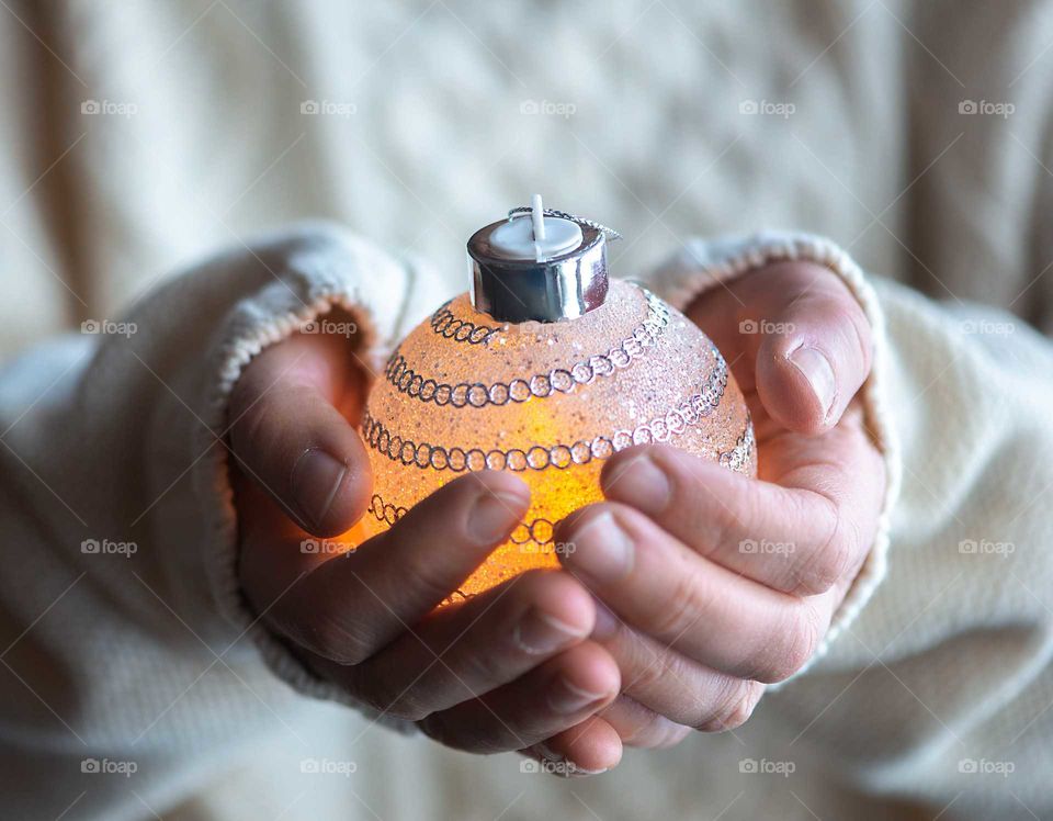 Close up of hands holding Christmas ball