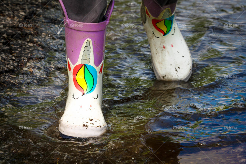 Rain boots with unicorns in use