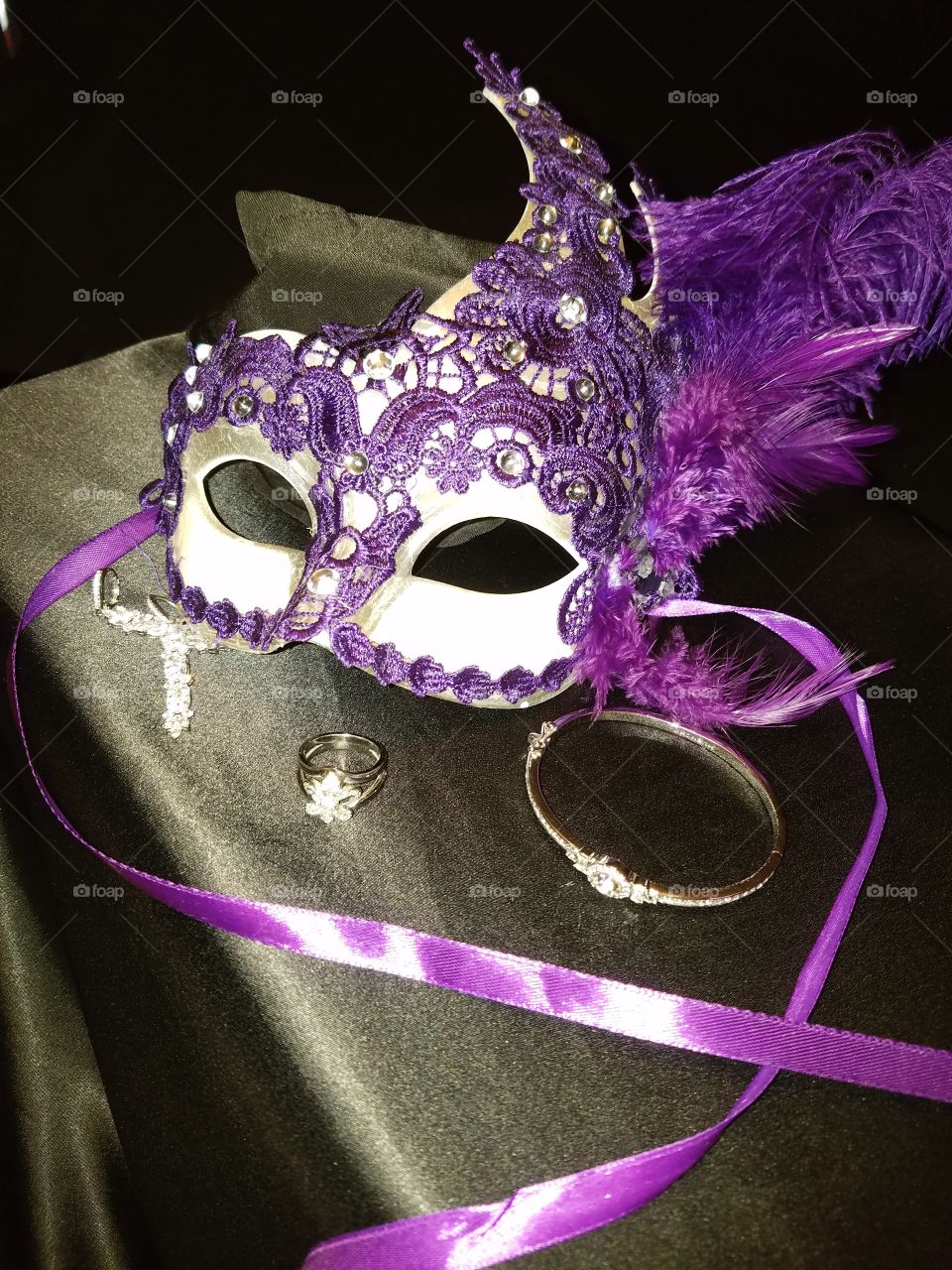 purple lace Mardi Gras mask with purple feather purple satin ribbons diamond earrings a Florida Lee diamond ring and bracelet
