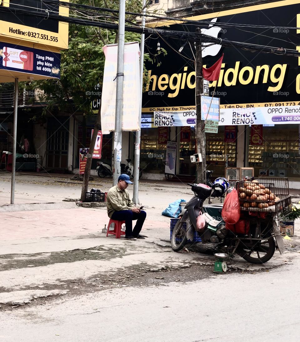 man selling oranges by the roadside
