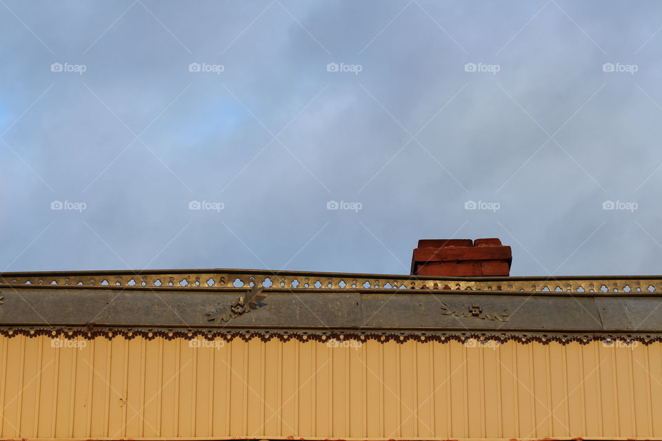 Close-up of traditional country house with chimney and birds in winter