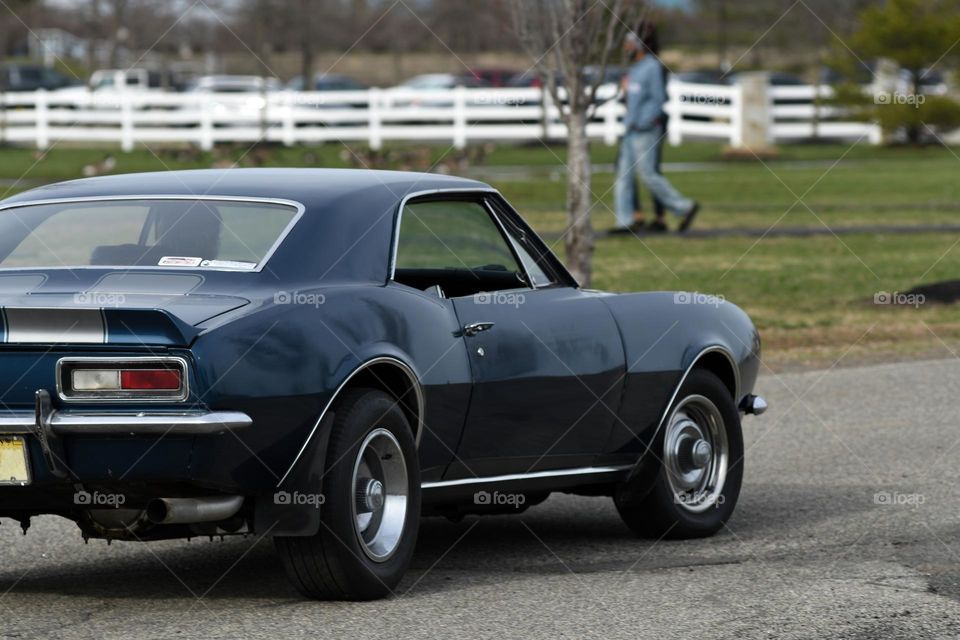A classic 1967 hard top Chevy Camaro cruises through Port reading waterfront Park in Woodbridge, NJ.