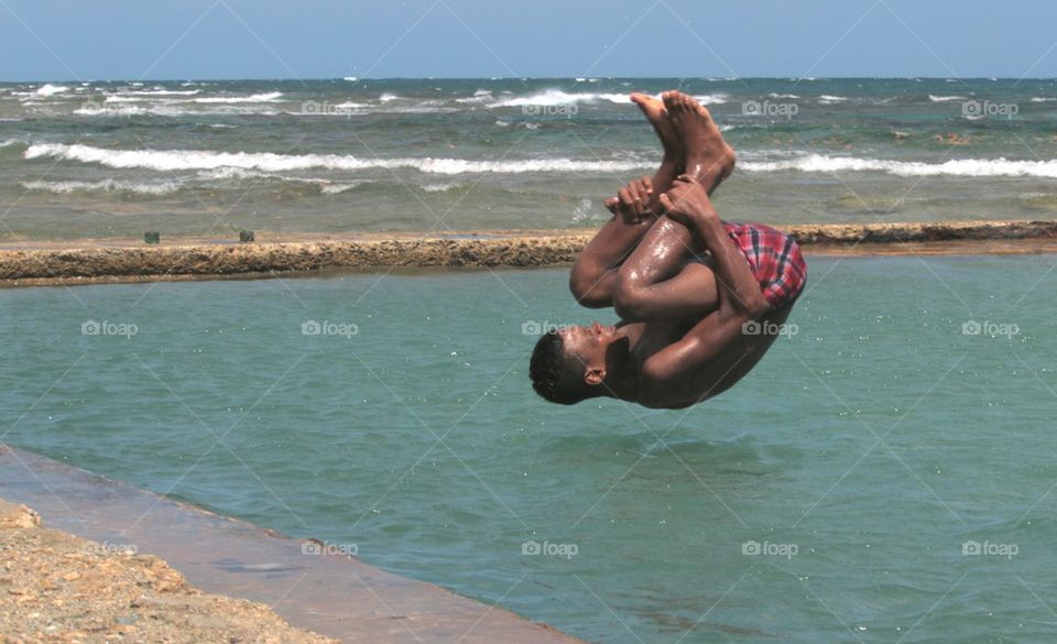 Young Boy Jumping Into Pool