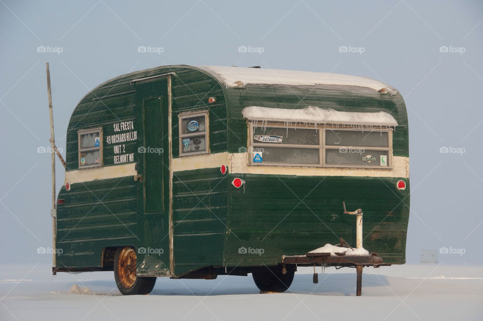 Icefishing in about a house made out of a Camper