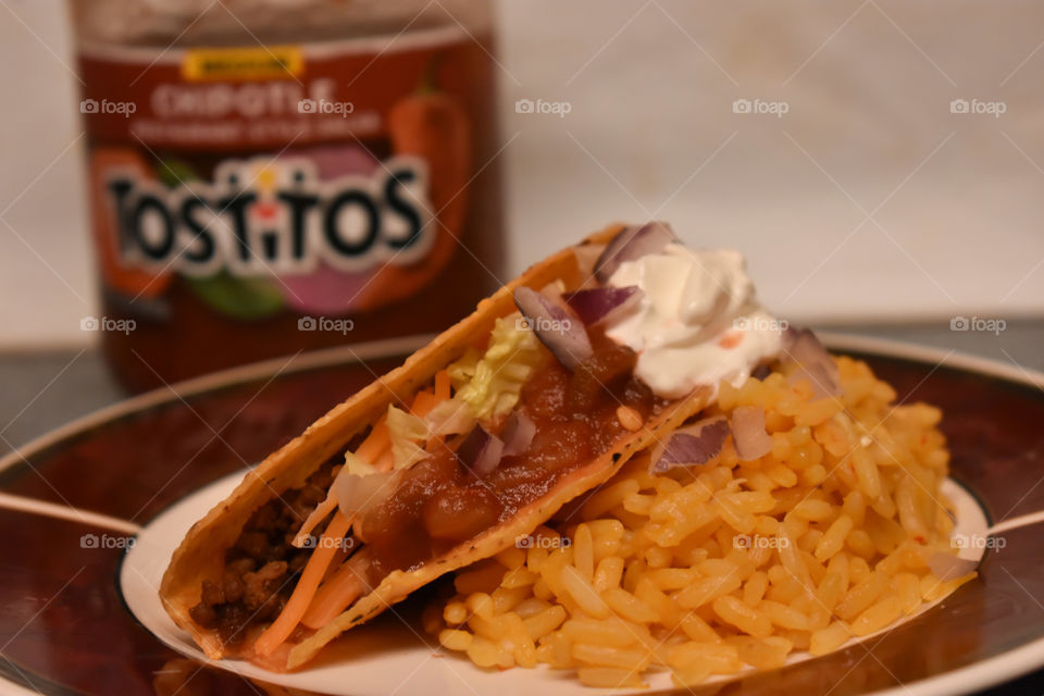 Tostitos salsa on my taco with yellow rice.
