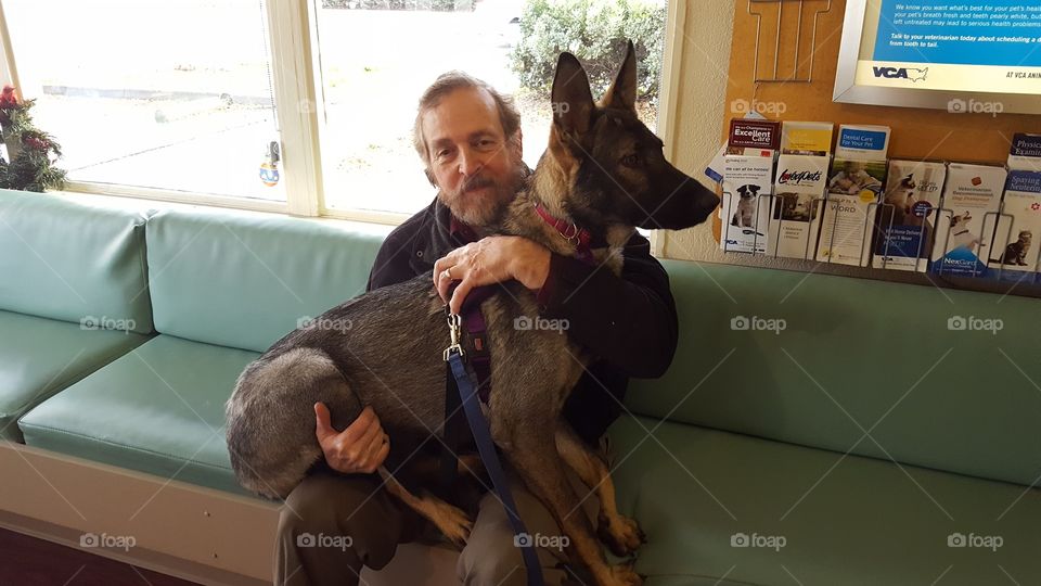 Man sitting on sofa with dog