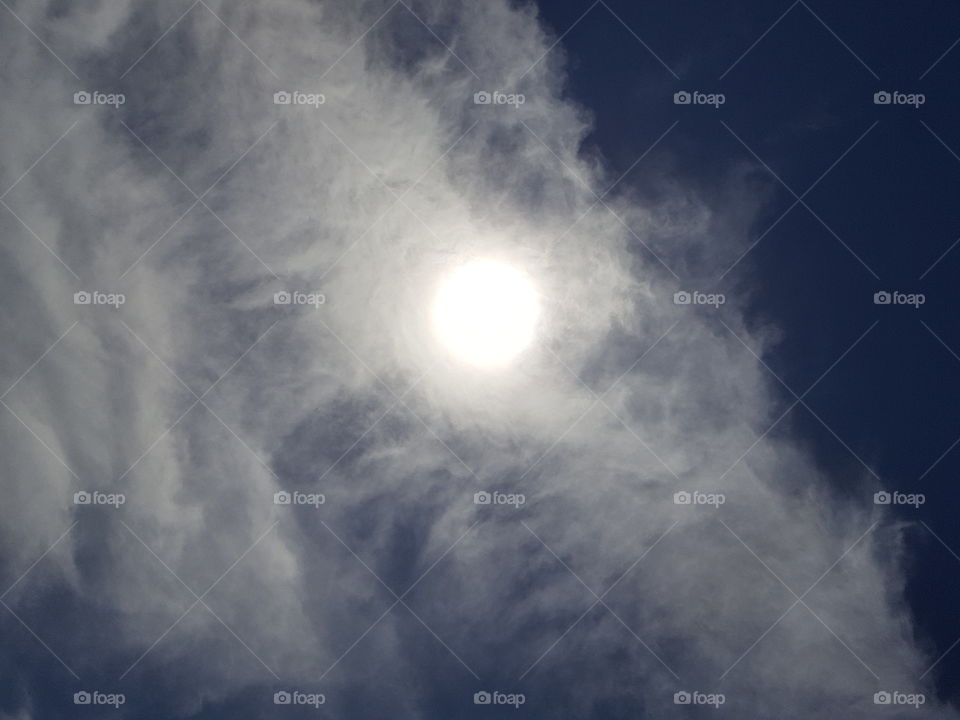 sun behind cloud