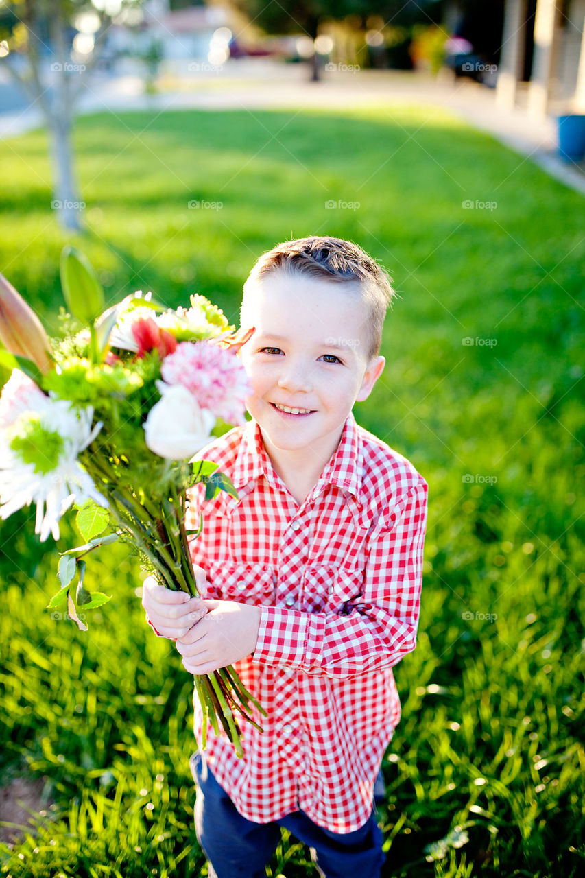 Little boy holding flowers
