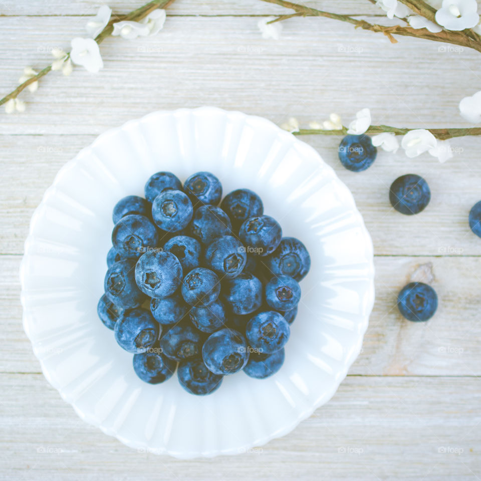 Fresh Blueberries on a White Plate Flatlay