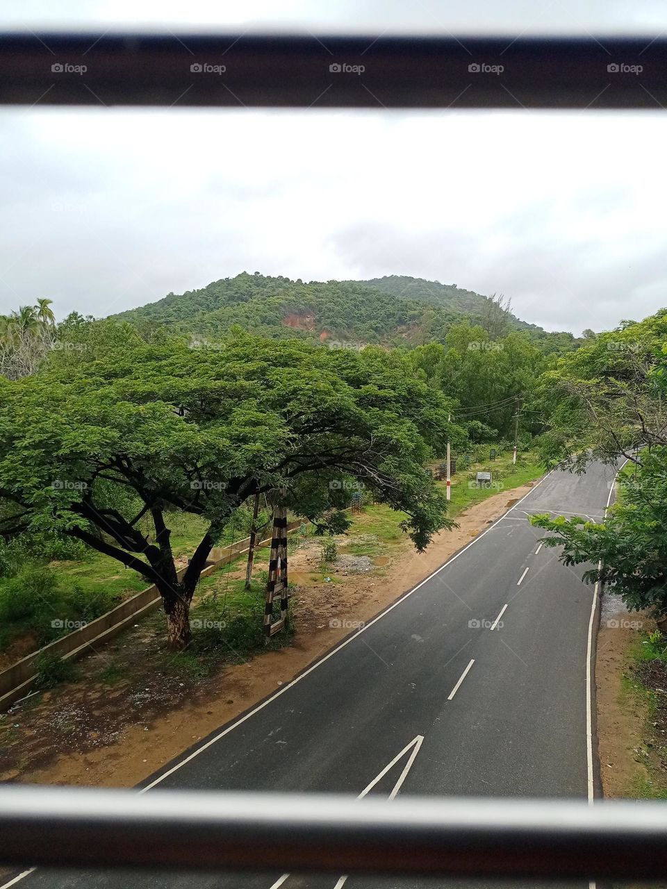 Beautiful view of the road under the train window with nice background of nature in rainy season nature photography