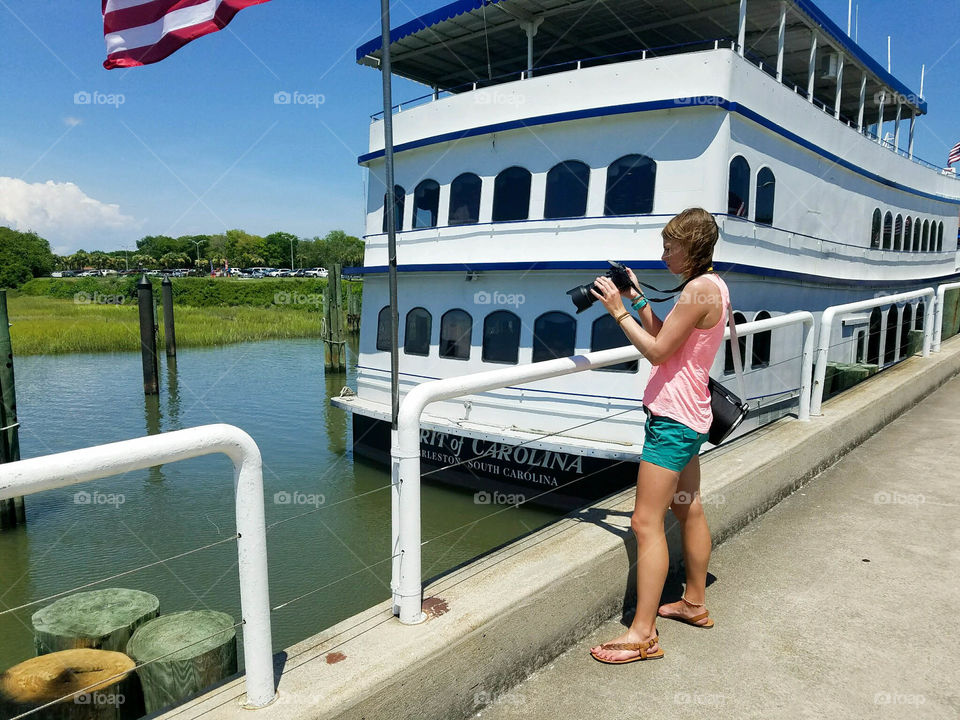 Photographer using a camera on a pier in Charleston, SC