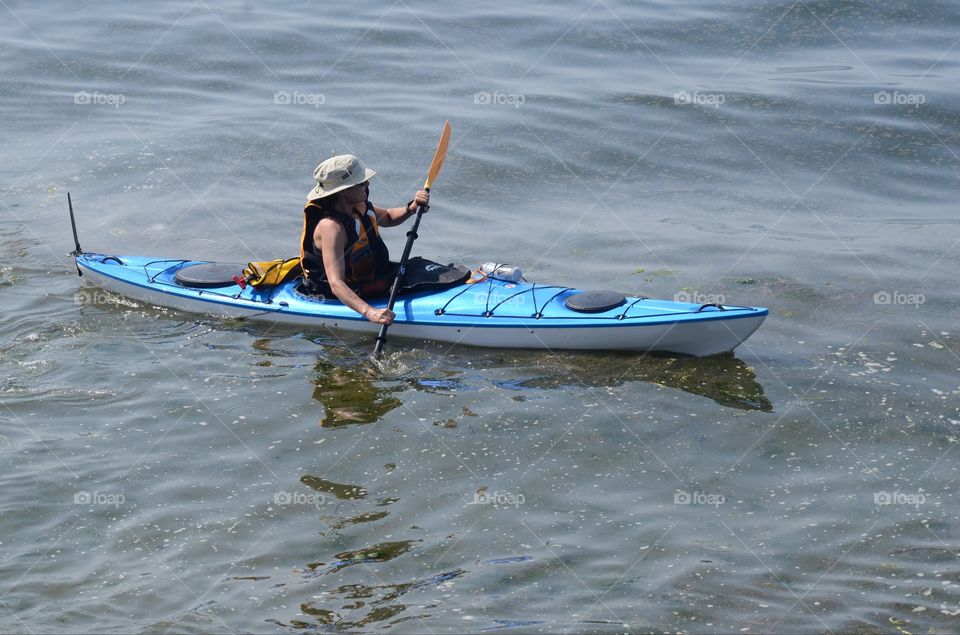 Kayaker paddles off into a kayaking competition in the Puget sound of West Seattle, Washington.