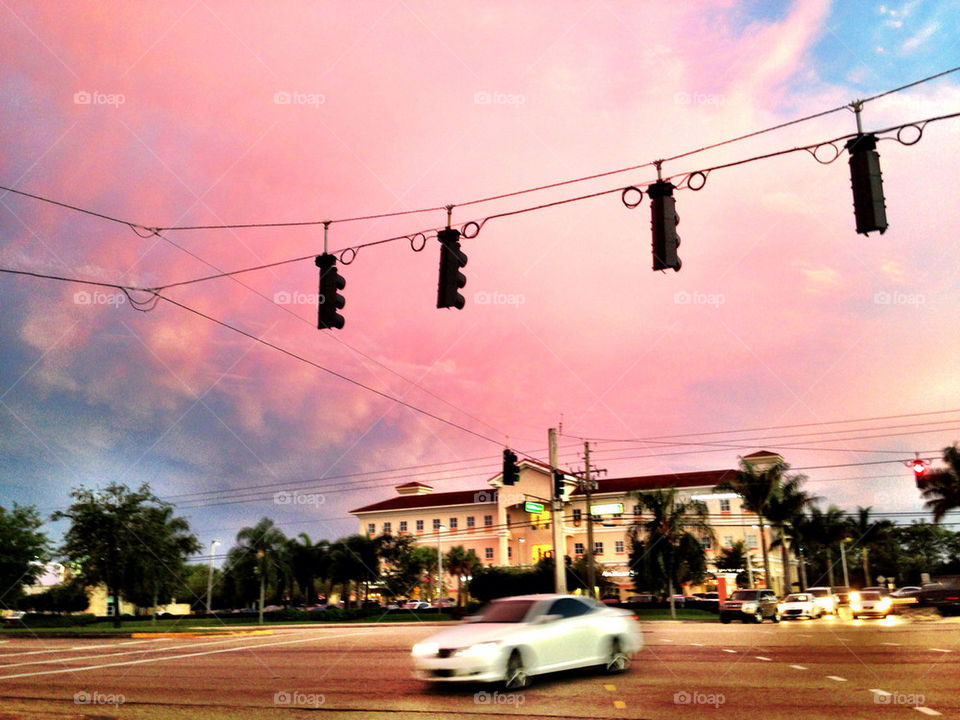 Car and traffic light at sunset