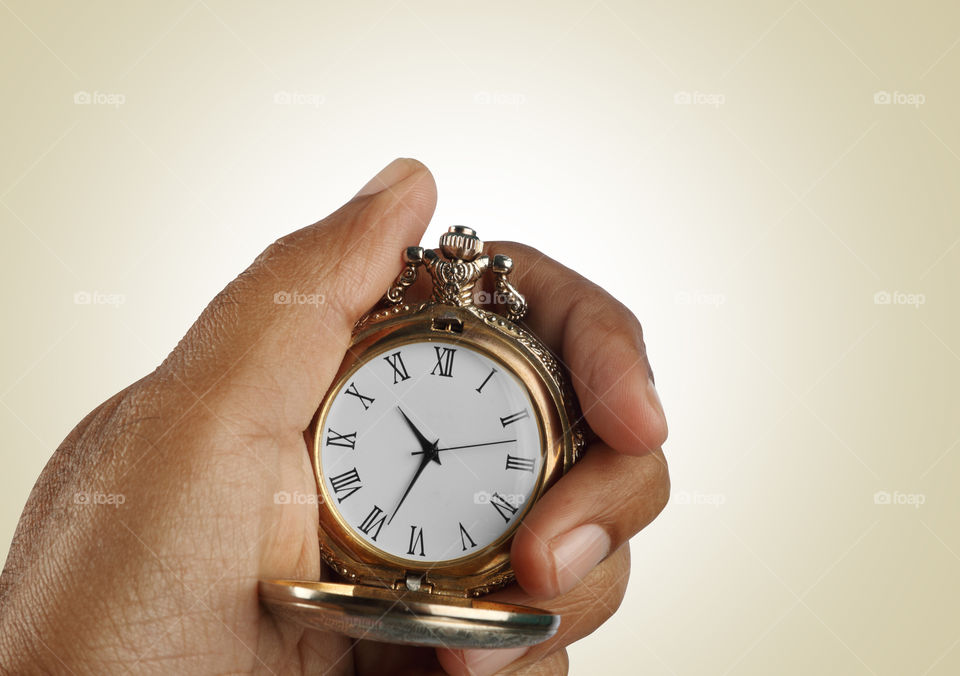 Antique pocket watch in a hand