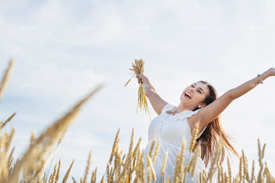 happy woman in wheat field