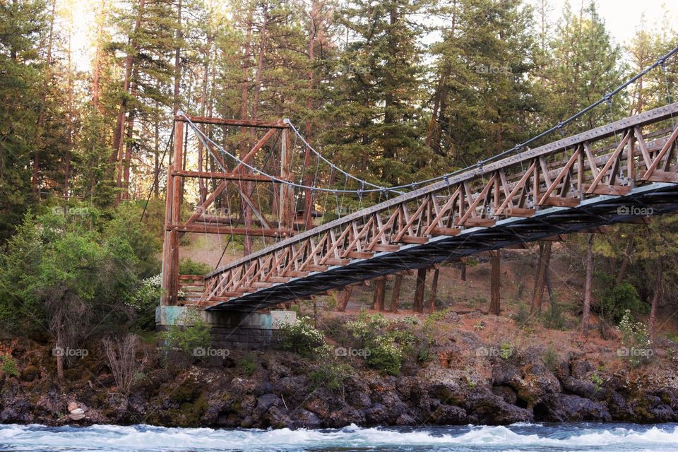 Wooden bridge over flowing river