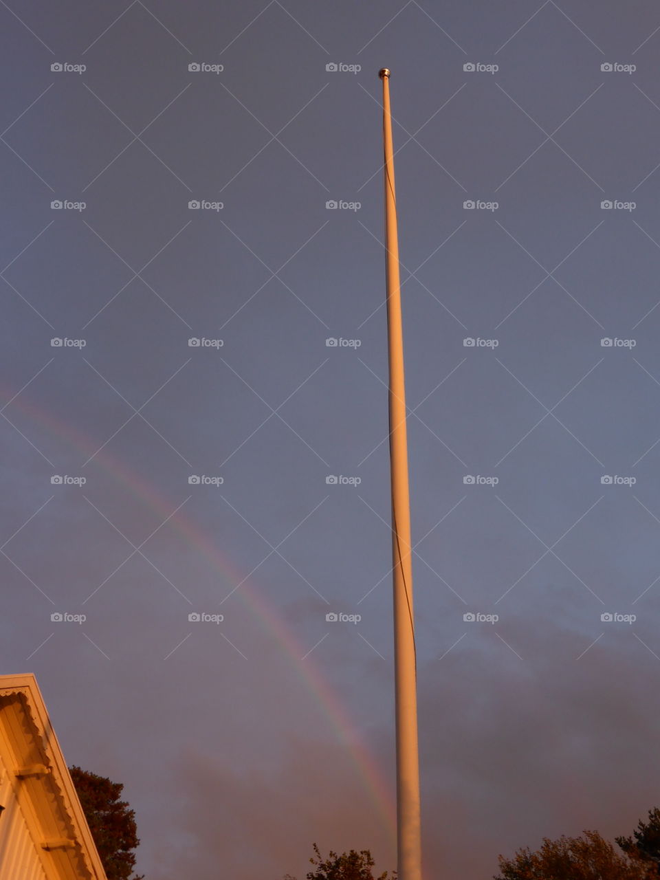 Rainbow and flagpole. Rainbow and flagpole