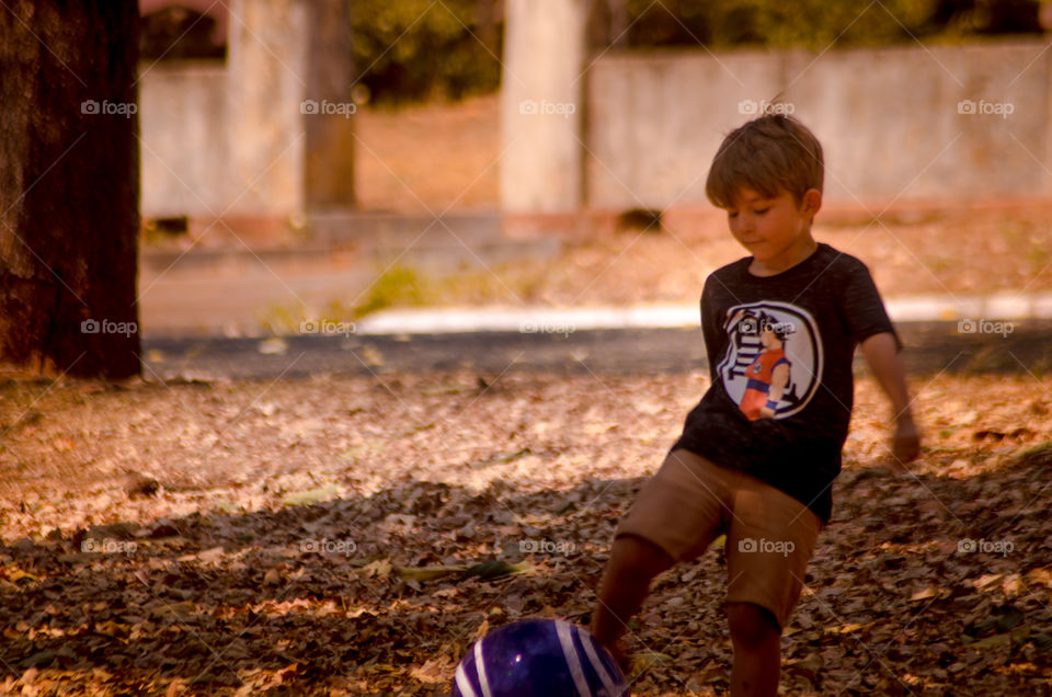 beautiful child playing ball on the farm