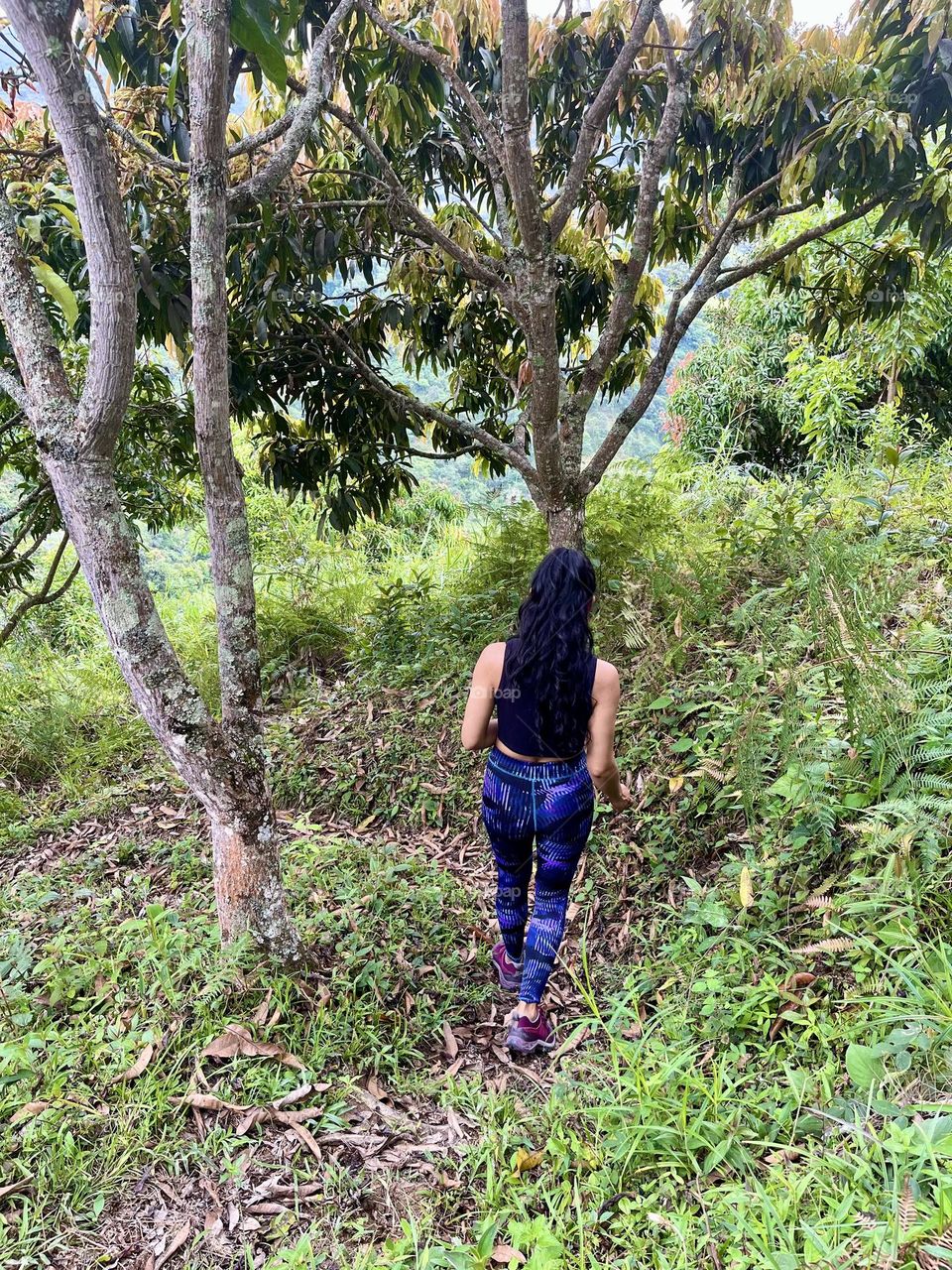 A woman walking in the middle of the forest
