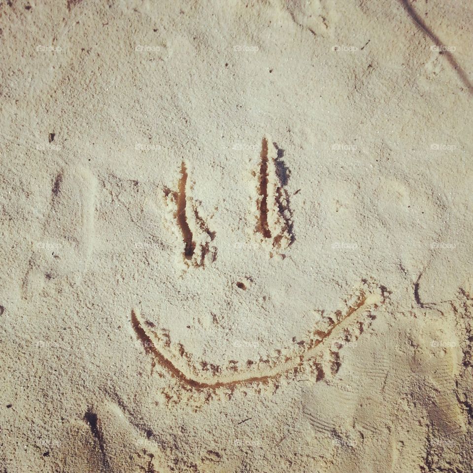 smile in the sand. my niece drew this in the sand