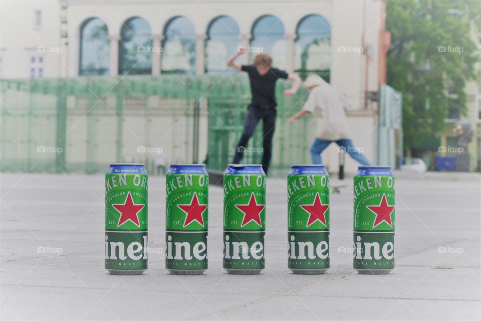 Two guys looking as if they are walking on the cans. Heineken gives this performance 5 stars!