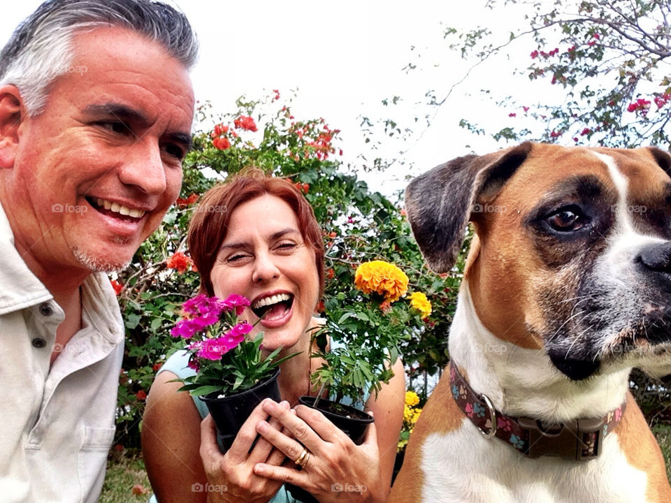 Couple with dog and flowers I backyard