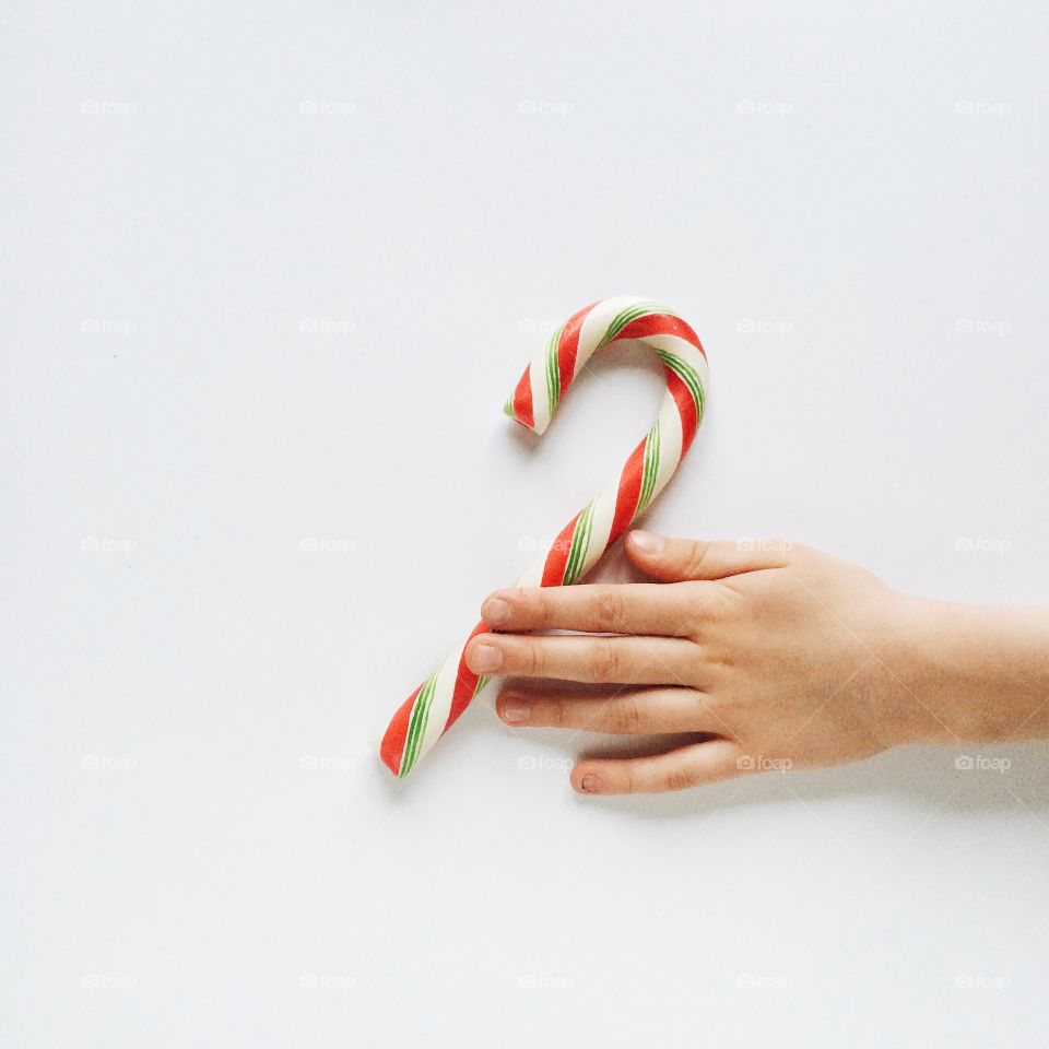 Close-up of hand with candy cane