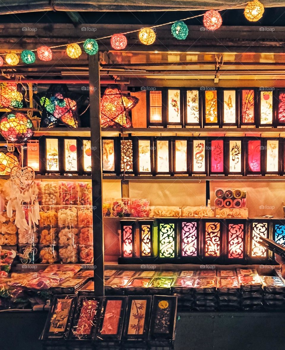Night market walk in front of lamp stalls