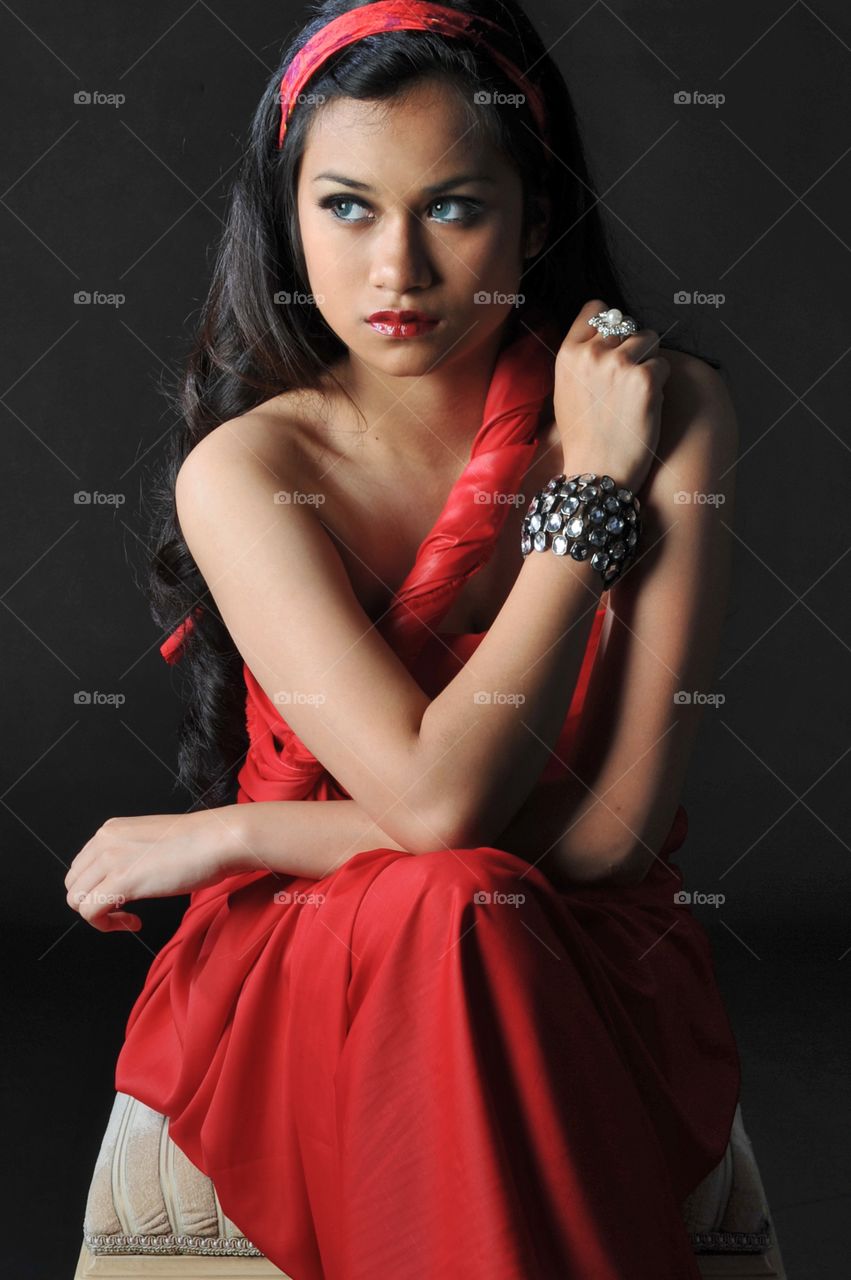 Teenage girl posing in red dress