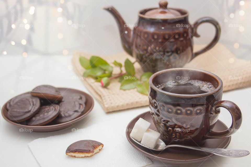 Morning Breakfast-tea with cookies. Brown dishes on a light background.