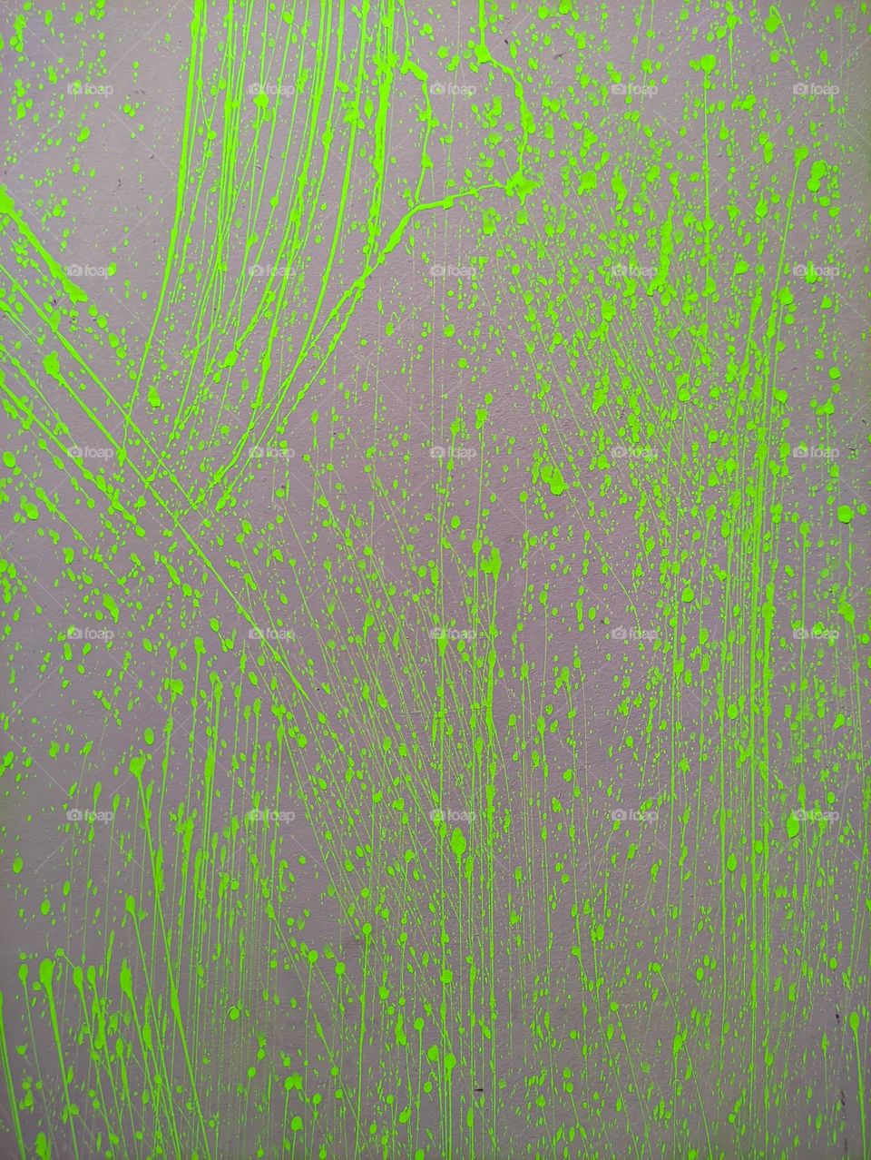 splashes of highlighter green paint stuck to the wall