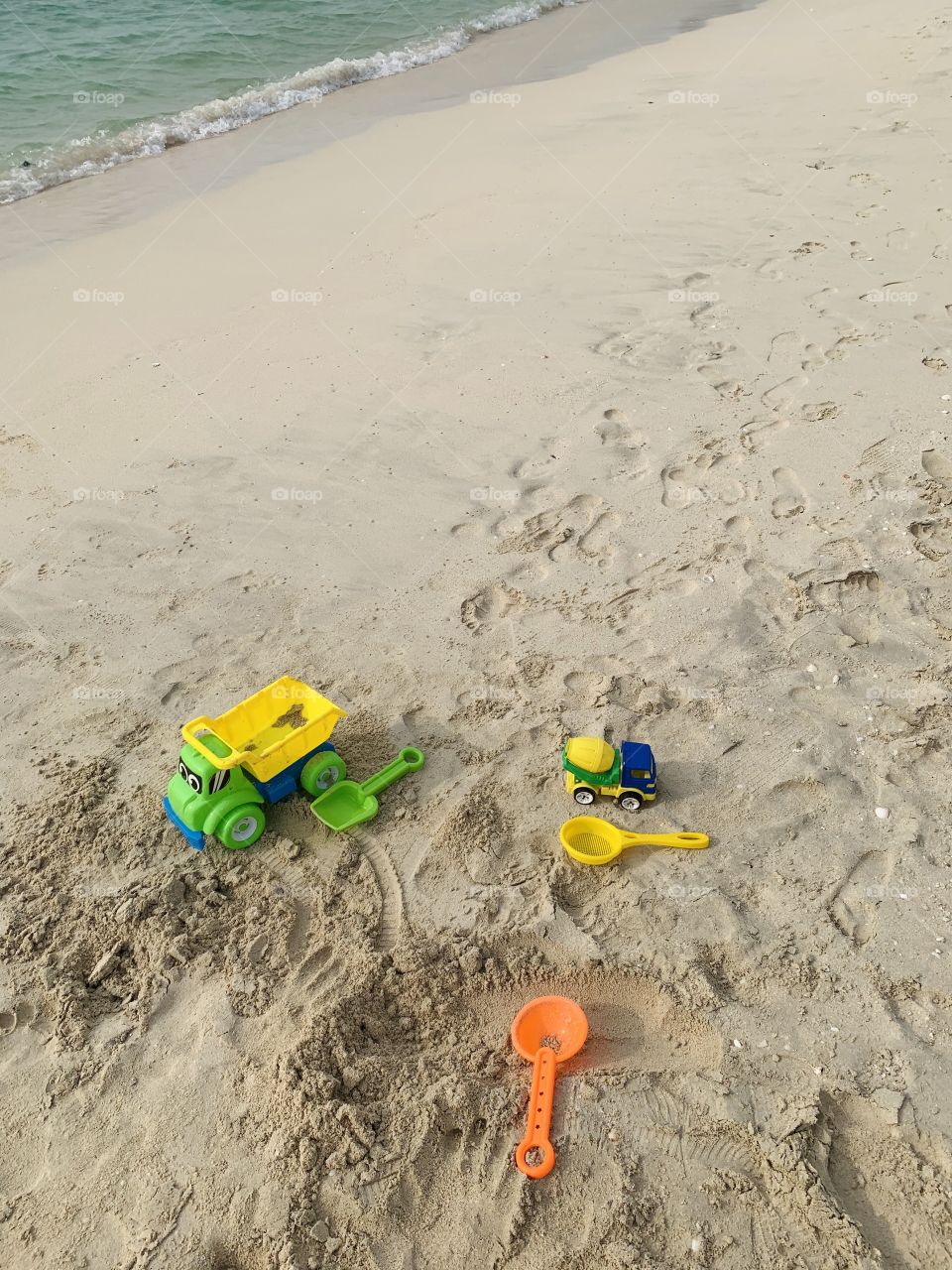 Kids plastic toy at sea beach sand 