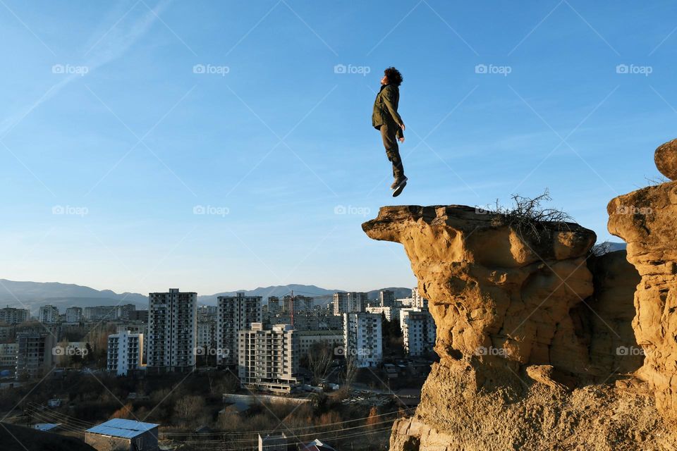 Man jumping on a cliff 
