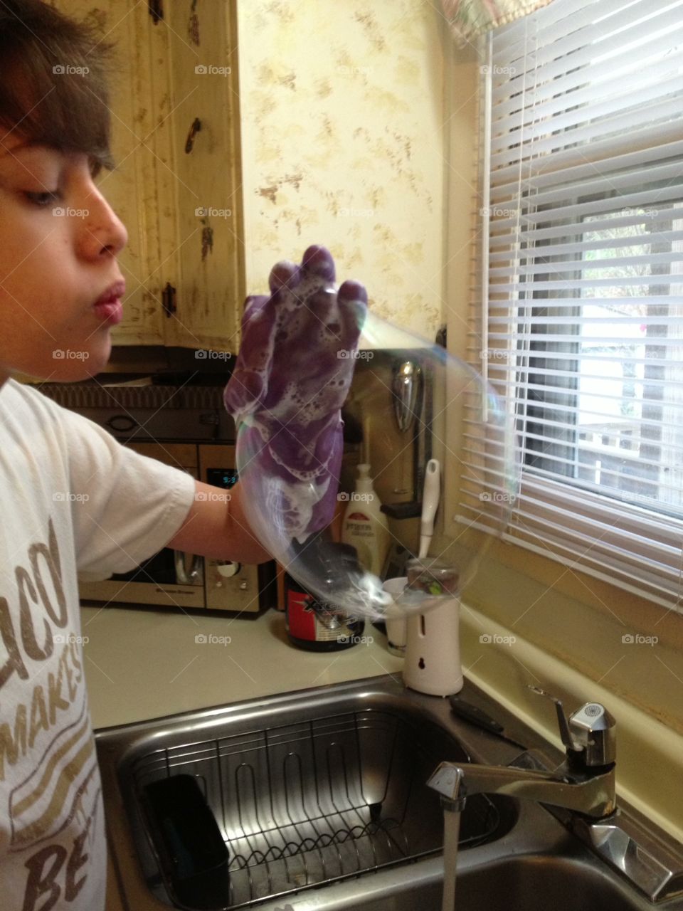 Having fun while washing the dishes. 