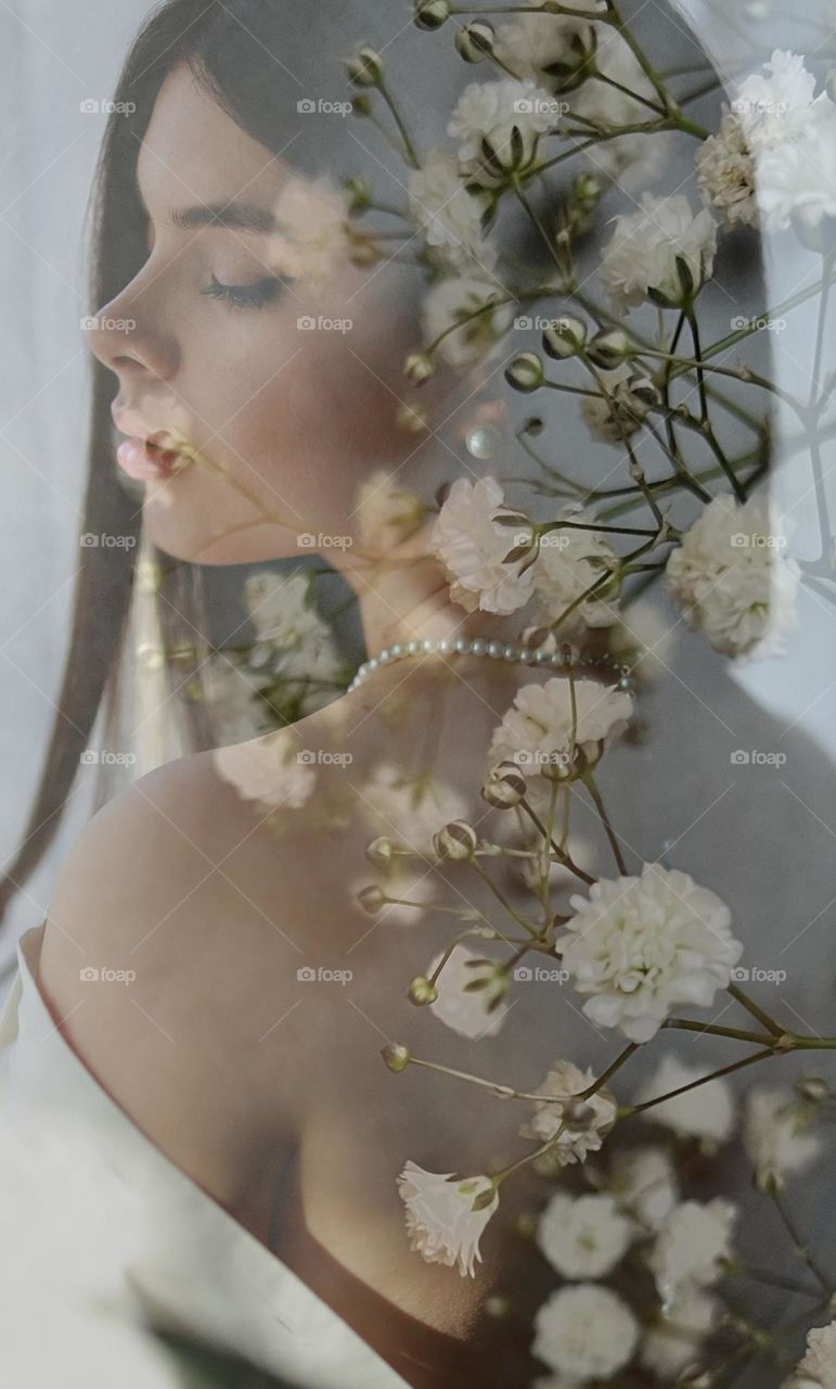 Natural beauty and femininity. Young lady with long hair. Beautiful portrait. White flowers and young women.