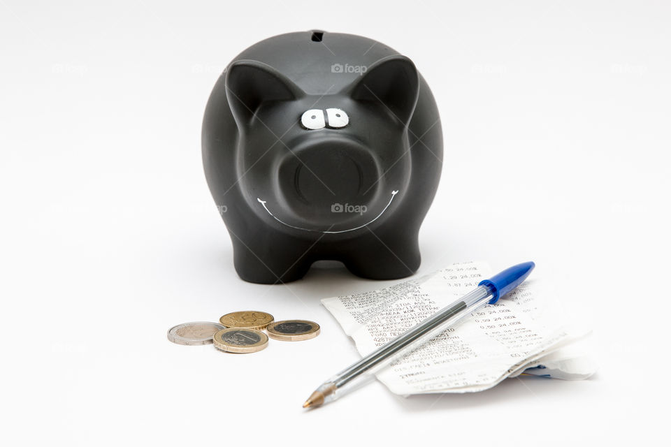 Black Piggy Bank With Coins,  Pen And Sales Receipt Isolated In White Background
