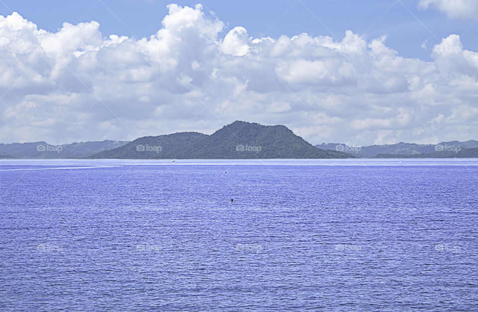 Tourists snorkel the beautiful sea The background mountains and beautiful sky with clouds