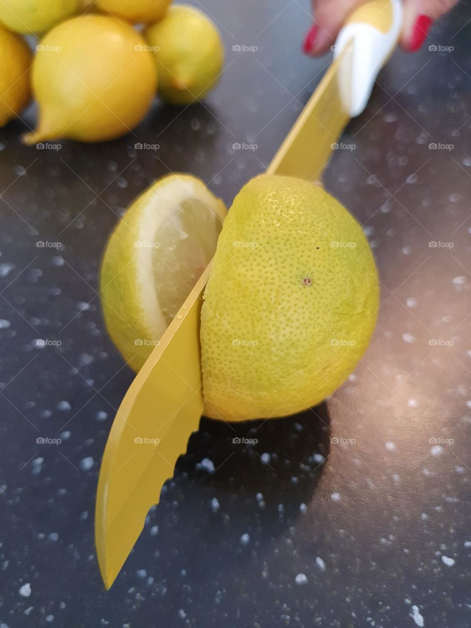 cut lemon with yellow knife