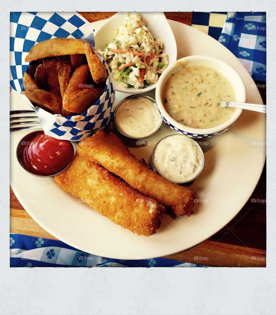 Complete Fish & Chips. Serving of fish & chips with cole slaw, ketchup and new england clam chowder