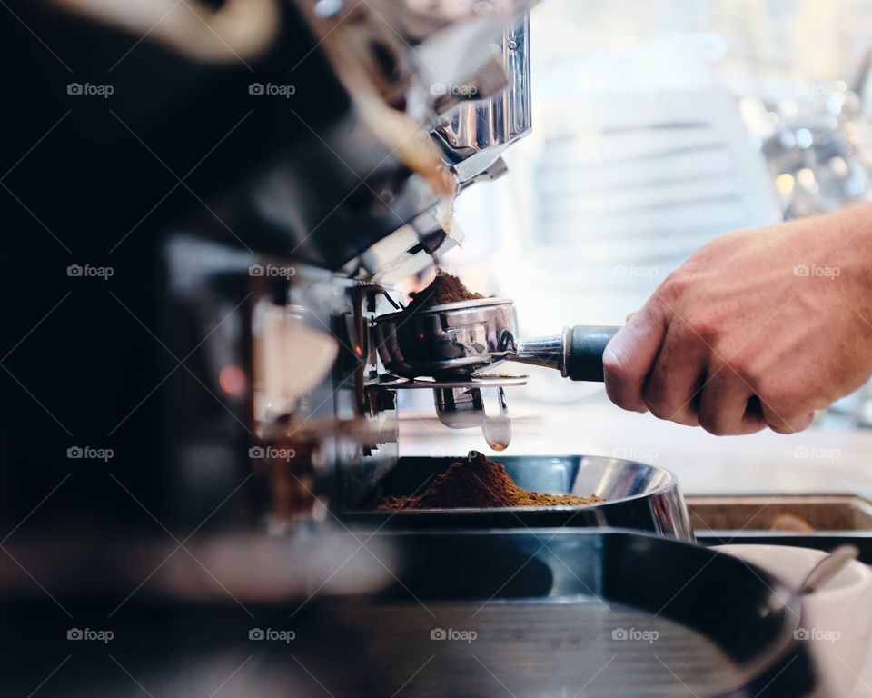 Men grinding fresh coffee