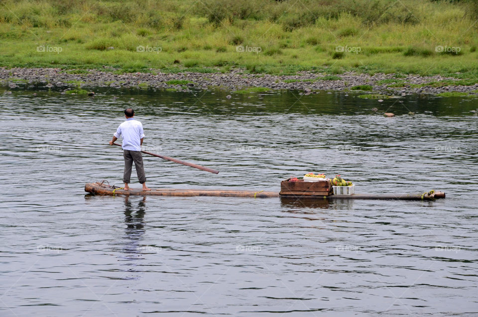 Life along the Li River, a Chinese man transporting fruits and vegetables!