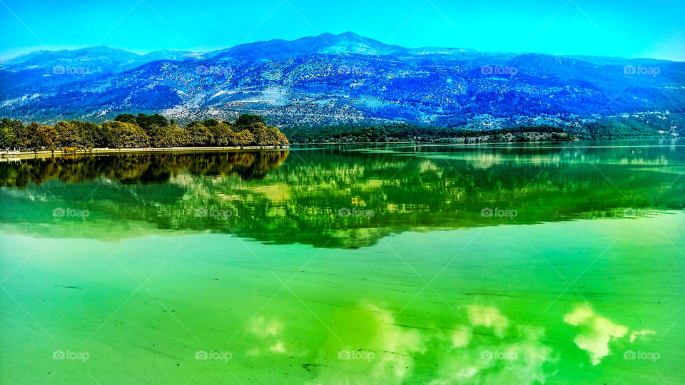 View of the moss-covered green colored lake of city Ioannina in Greece