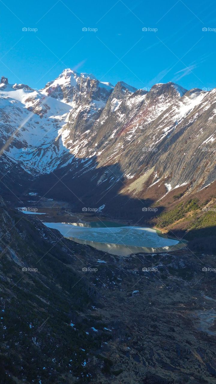 lagoon between mountains and blue clear sky.
