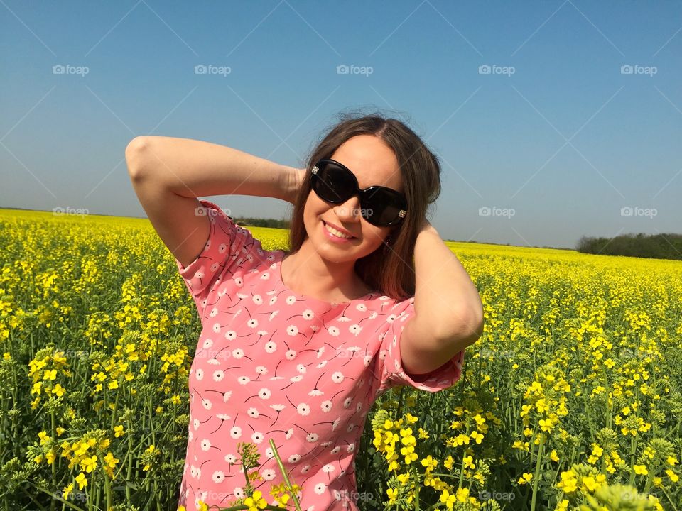 Portrait of beautiful woman standing in flowers field